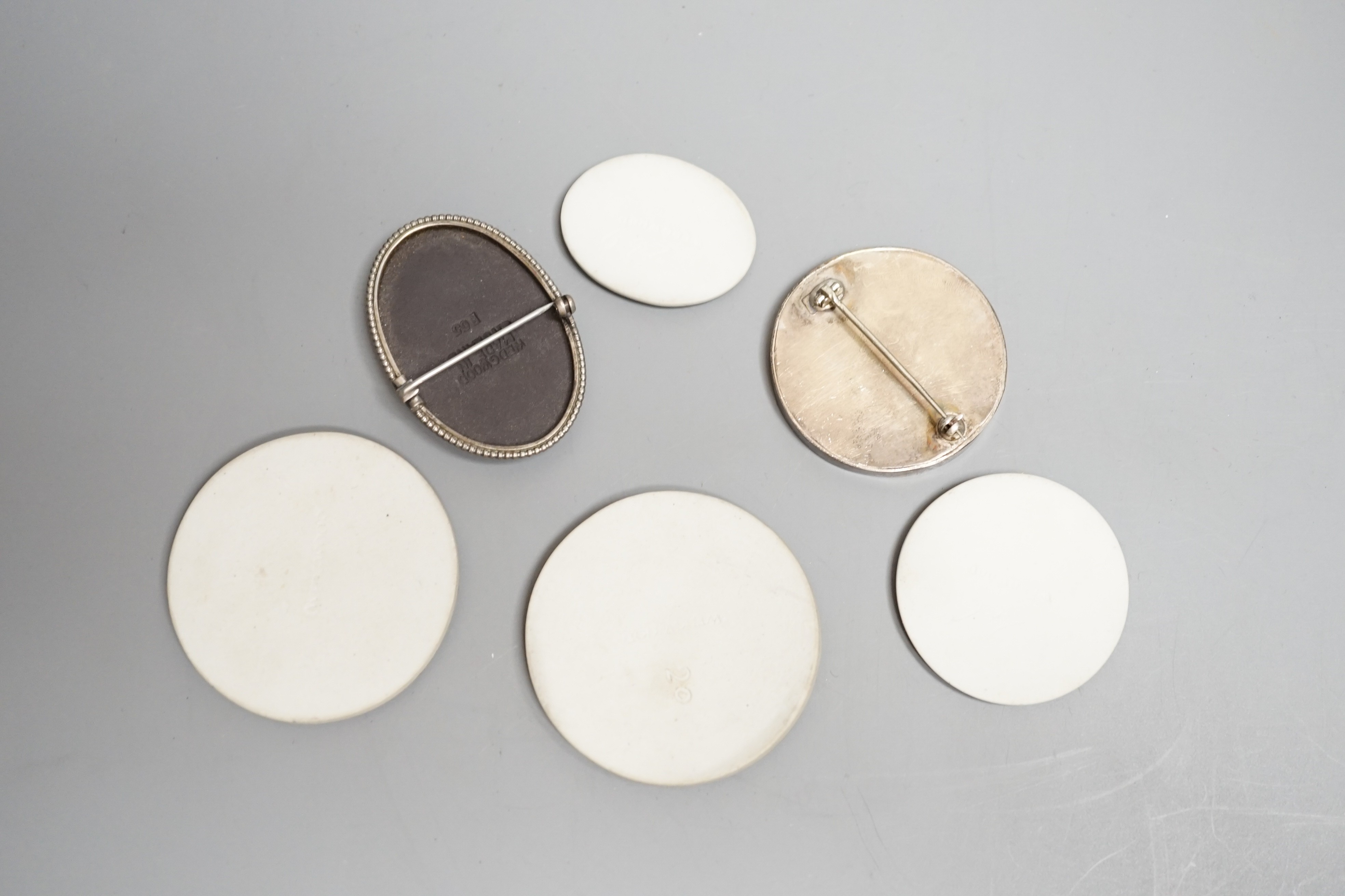 Two Wedgwood jasperware brooches, 20th century and four 19th century Wedgwood jasper plaques, largest 5.2 cm diameter